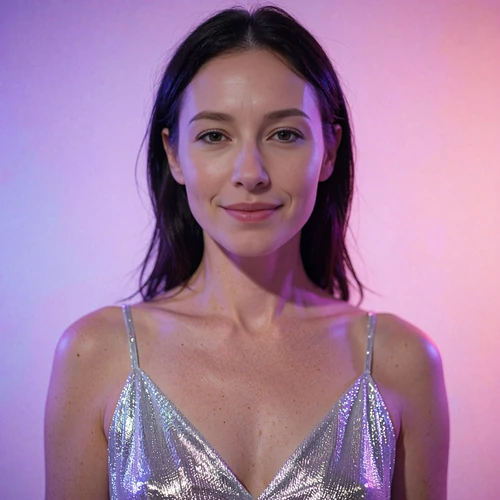 Portrait of a woman in a shimmering silver dress smiling under violet neon light